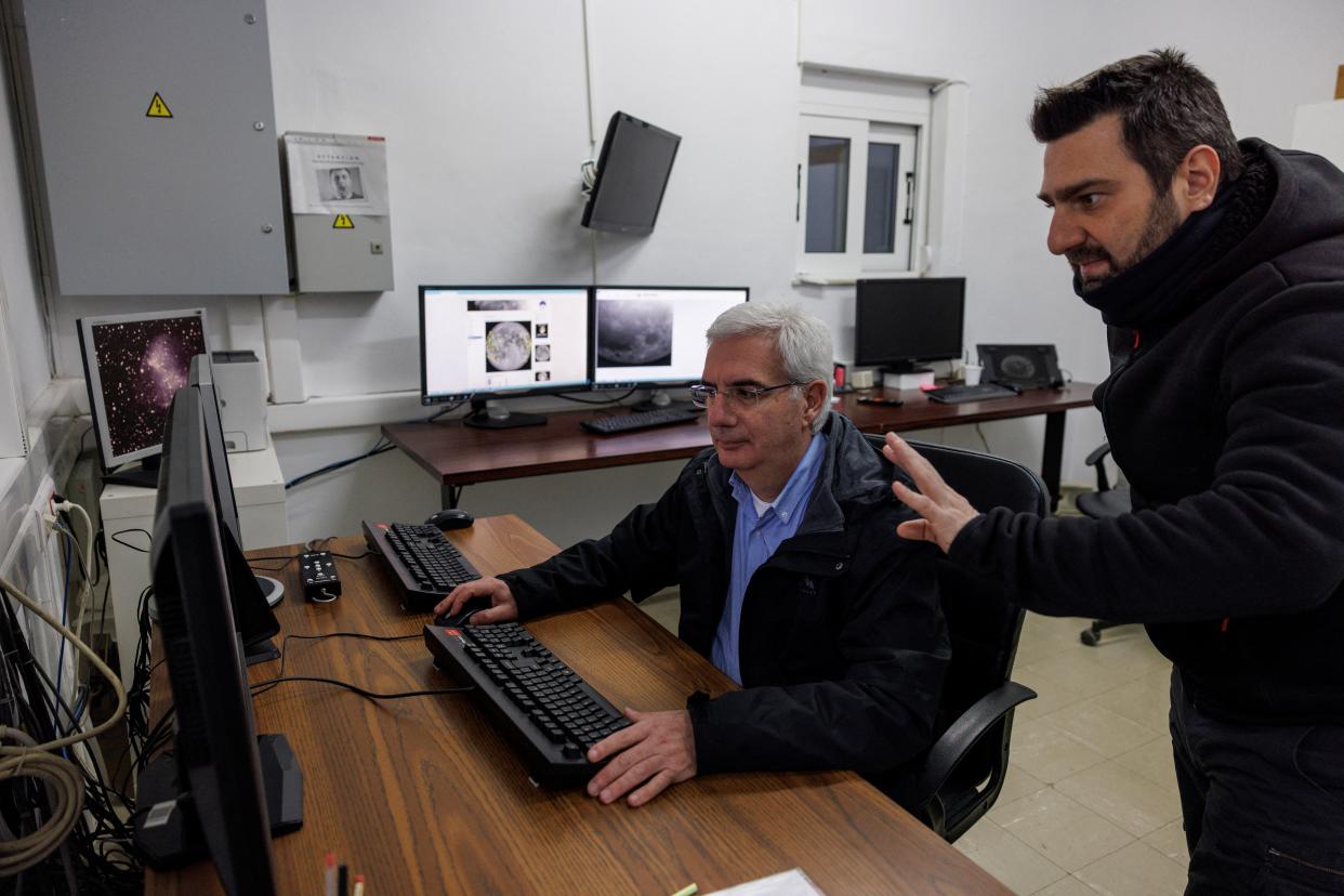 Post doctoral researcher Alexios Liakos talks to senior researcher Manolis Xylouris, as they track a green comet named Comet C/2022 E3 (ZTF) from the telescope of the Kryoneri observatory, in Kryoneri, Greece, February 1, 2023. (REUTERS)