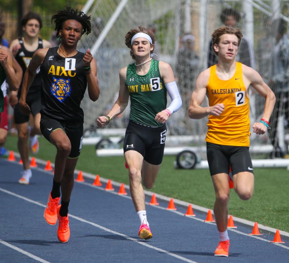 Salesianum's Ethan Walther (right) stays ahead of second place A.I. du Pont's Camerin Williams (left) and third-place Brian Yeager of Saint Mark's as he heads for the final strides of his win the 800 meter race during the New Castle County track and field championships, Saturday, May 11, 2024 at Abessinio Stadium.
