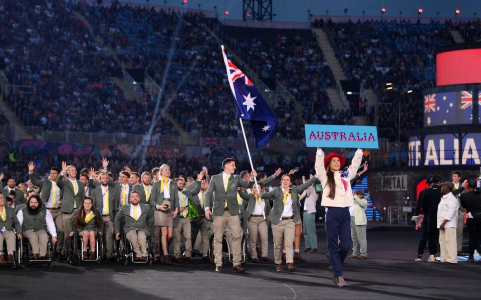 ddie Ockenden and Rachael Grinham, Flag Bearers of Team Australia lead their team out during the Opening Ceremony - GETTY IMAGES