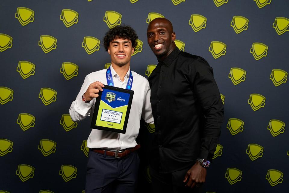 Devan Kipyego, of St. Raphael Academy, with former Patriot Devin McCourty.