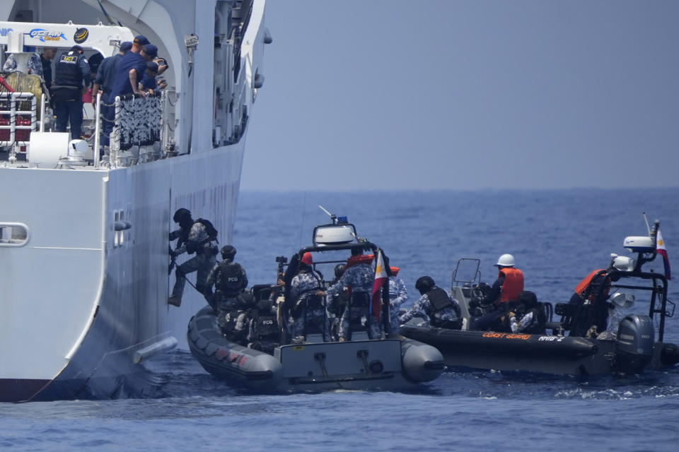 Armed Philippine Coast Guard personnel board the PCG Melchora Aquino ship during a Coast Guard drill off the waters of Bataan, Philippines., Tuesday, June 6, 2023. Philippines, U.S. and Japanese coast guard participated in exercises which involved drills on maritime law enforcement and security.(AP Photo/Aaron Favila)