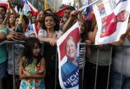 Supporters of Chilean presidential candidate Michelle Bachelet celebrate after hearing the results of the second round vote at a hotel in Santiago, December 15, 2013. REUTERS/Eliseo Fernandez