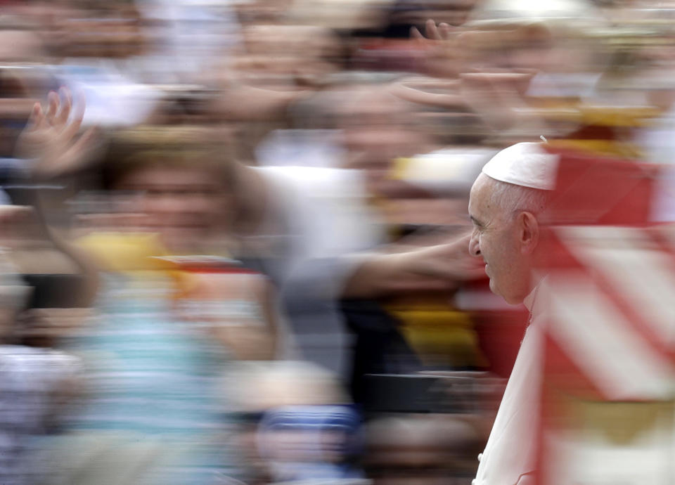 Pope Francis is driven through the crowd