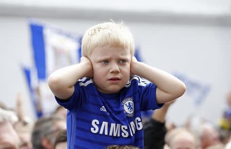 Football - Chelsea - Barclays Premier League Winners Parade - Chelsea & Kensington, London - 25/5/15 A Chelsea fan covers his ears during the parade Action Images via Reuters / Peter Cziborra Livepic