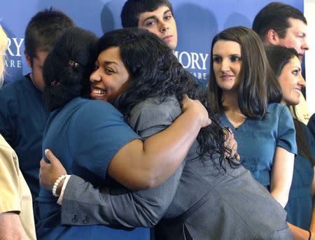 Amber Vinson hugs caregivers before her release from Emory University Hospital in Atlanta, Georgia October 28, 2014. REUTERS/Tami Chappell