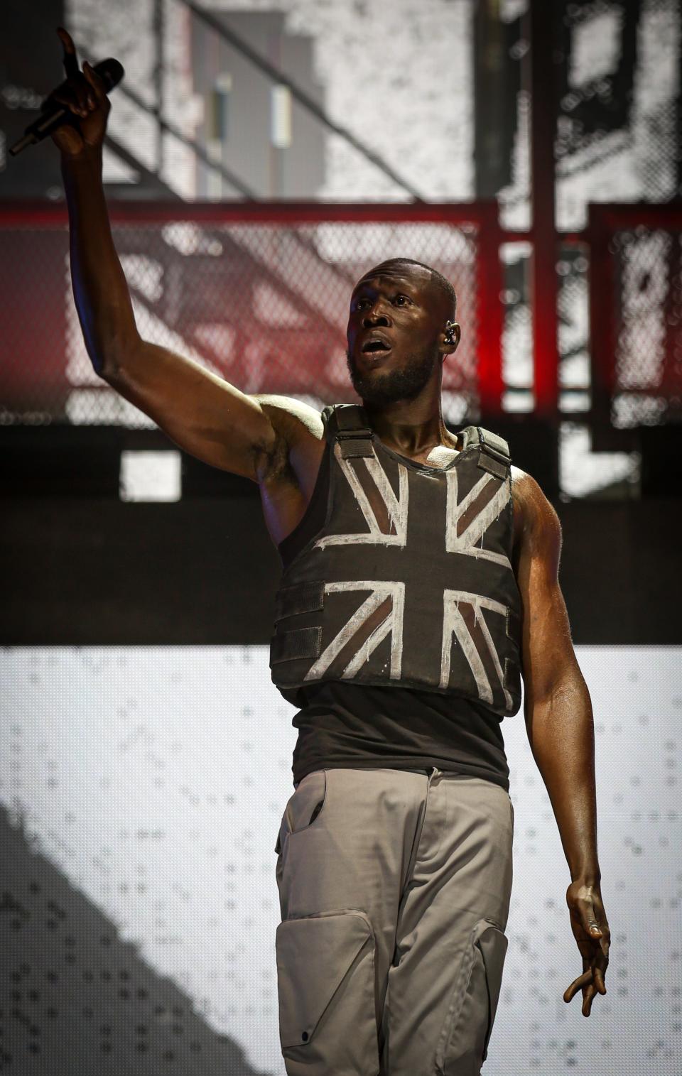 Stormzy, wearing a stab vest designed by the artist Banksy, performs on the Pyramid Stage at the 2019 Glastonbury Festival.