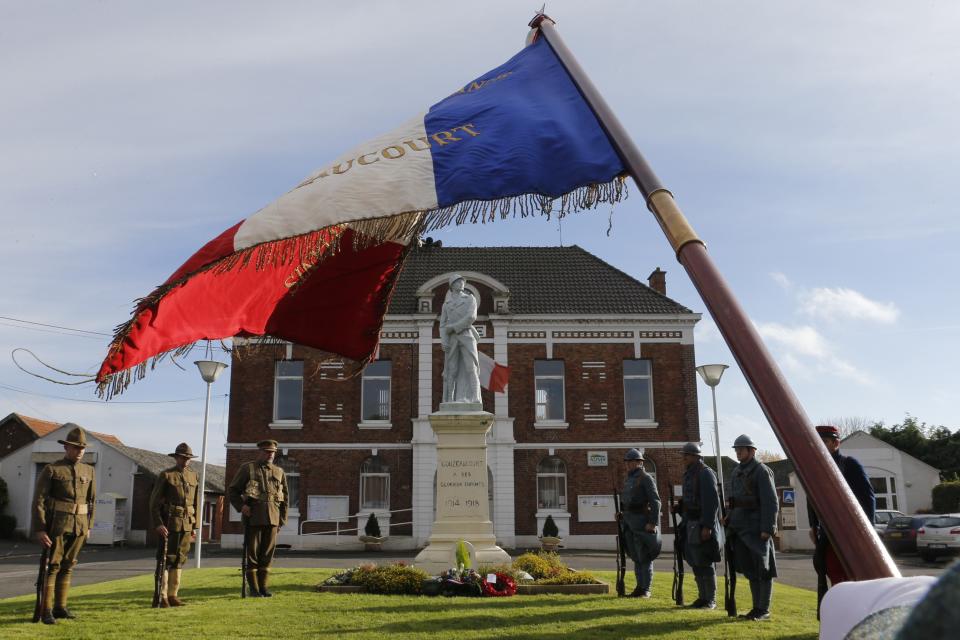 World War One Historical Association members dressed as Piou Piou and Poilu, Canadian soldier and U.S. soldier attend Armistice ceremony at the war memorial of Gouzeaucourt