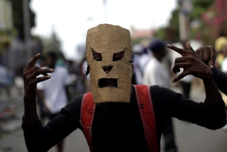 A protester gestures as he marches during a demonstration called by artists to demand the resignation of Haitian president Jovenel Moise, in the streets of Port-au-Prince