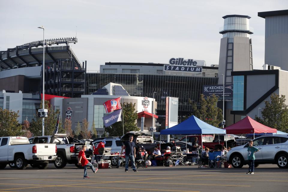 People tailgate outside Gillette Stadium before an NFL football game between the New England Patriots and the Miami Dolphins, Sunday, Sept. 16, 2023, in Foxborough, Mass. (AP Photo/Michael Dwyer)
