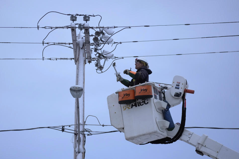 Central Maine Power Co. lineman John Baril works to restore electricity, Wednesday, March 15, 2023, in Lewiston, Maine. A late-winter storm dumped heavy, wet snow on parts of the Northeast, causing tens of thousands of power outages. (AP Photo/Robert F. Bukaty)