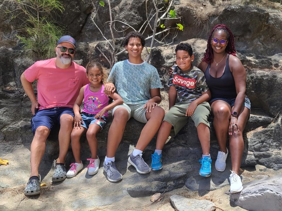 Kisha Stewart poses outdoors with her now family of five.