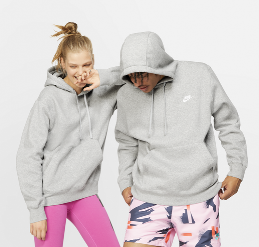 A promotional photo for the Nike Club Pullover Hoodie featuring a male and female model