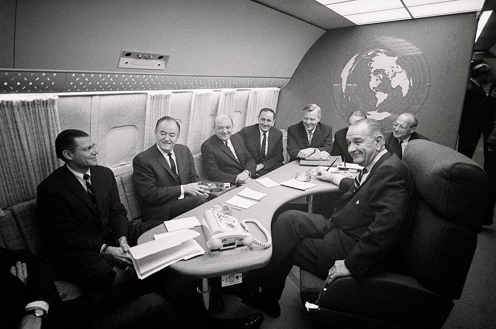 Lyndon Johnson meets with members of his Cabinet on Air Force One.