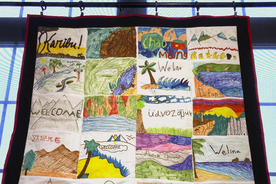 A handmade blanket, featuring "Welcome" in many languages, is displayed as part of the Welcome Blanket exhibit at the Winooski Heritage Mill Museum, Feb. 17, 2023, in Winooski, Vt. Blankets, made by Vermont and out-of-state crafters, were given away to refugees. (AP Photo/Lisa Rathke)