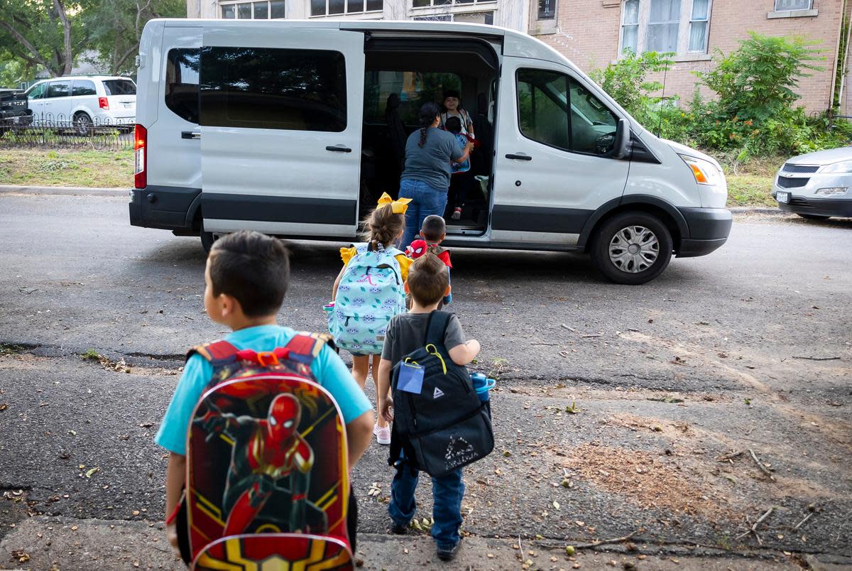 Kindergarten students are loaded into a van by Pita Espinosa so they can be driven to their elementary school from the Learning Tree childcare center in Yoakum, on Sept. 13, 2022.