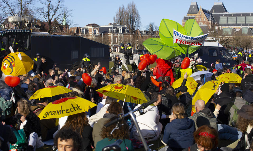 Dutch riot police enclose a group of demonstrators who refused to leave after police broke up a demonstration of hundreds of people who protested against the coronavirus lockdown and curfew on Museum Square in Amsterdam, Netherlands, Sunday, Feb. 28, 2021. The group was eventually allowed to leave. (AP Photo/Peter Dejong)