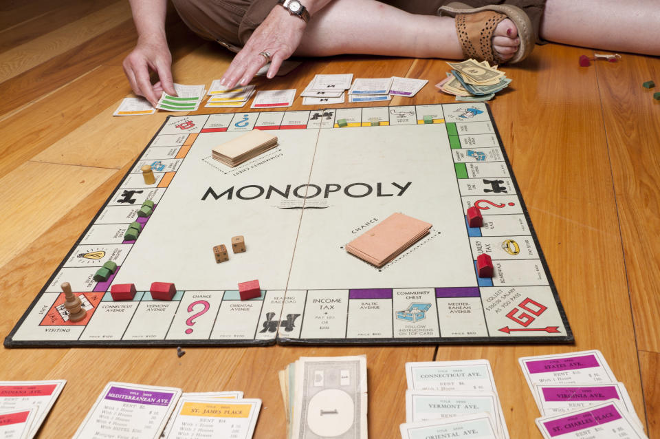 Phoenix, United States - June 18, 2011: Monopoly is a board game in which the players purchae property, build houses and hotels, and charge for other players who land on their property.  The winner is determined when one player has so much money and property that the other players are bankrupted.