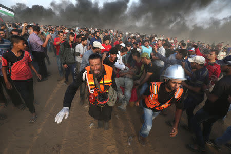 A wounded Palestinian is evacuated during a protest calling for lifting the Israeli blockade on Gaza and demanding the right to return to their homeland, at the Israel-Gaza border fence in the southern Gaza Strip October 19, 2018. REUTERS/Ibraheem Abu Mustafa