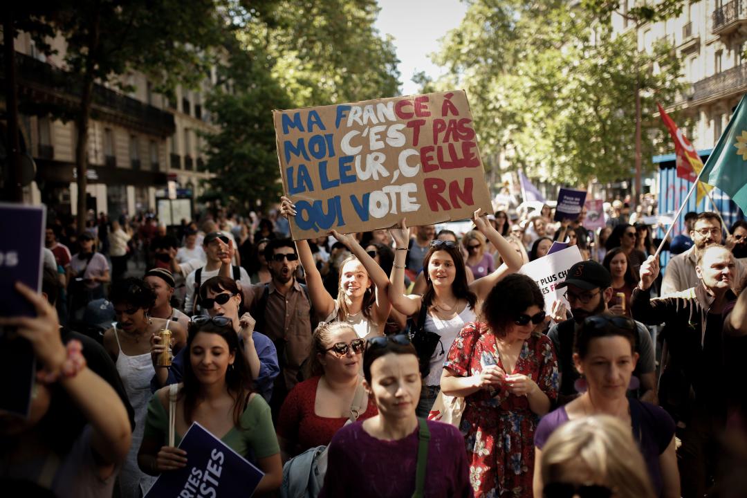 Paris, France. 23rd June, 2024. Protesters march chanting slogans and holding placards reading 