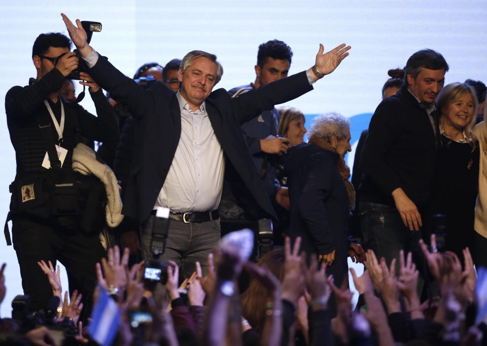 Presidential candidate Alberto Fernandez addresses supporters at the "Frente de Todos" party headquarters after primary elections in Buenos Aires, Argentina, Sunday, Aug. 11, 2019. The "Frente de Todos" presidential ticket with former President Cristina Fernández emerged as the strongest vote-getter in Argentina’s primary elections Sunday, indicating conservative President Mauricio Macri will face an uphill battle going into general elections in October. (AP Photo/Sebastian Pani)