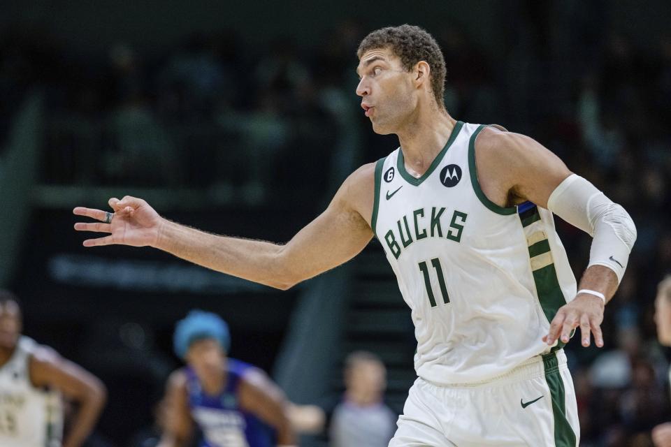 Milwaukee Bucks center Brook Lopez (11) celebrates after a 3-point basket during the second half of the team's NBA basketball game against the Charlotte Hornets on Saturday, Dec. 3, 2022, in Charlotte, N.C. (AP Photo/Scott Kinser)