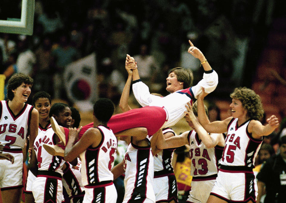 FILE - U.S. women's basketball coach Pat Summitt is carried off by members of the team following their 85-55 Olympic gold medal win over South Korea in Los Angeles, Aug. 8, 1984. (AP Photo/Pete Leabo, File)