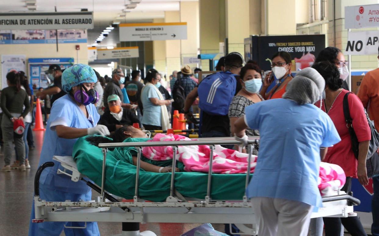 Nurses transport a patient amid the COVID-19 pandemic at the entrance of Alberto Sabogal Hospital in Callao, Peru, - AP Photo/Martin Mejia