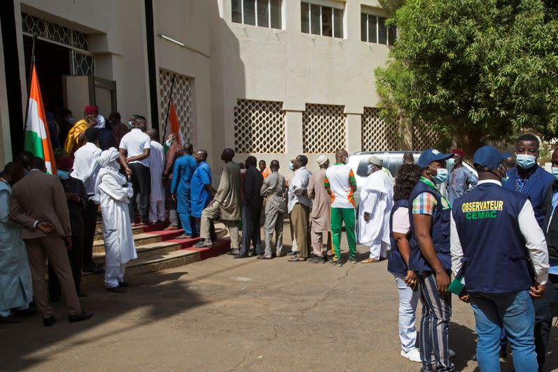 FILE PHOTO: Voters queue at a polling station during the second round of the country's presidential election, in Niamey