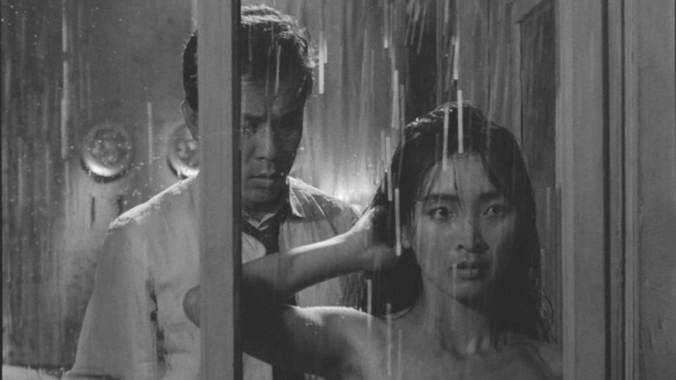 A still from the housemaid shows a woman showering while man watches