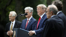 President Donald Trump speaks in the Rose Garden of the White House, Friday, May 29, 2020, in Washington, As White House trade adviser Peter Navarro, left, White House national security adviser Robert O'Brien, and White House chief economic adviser Larry Kudlow, far right, listen. (AP Photo/Alex Brandon)