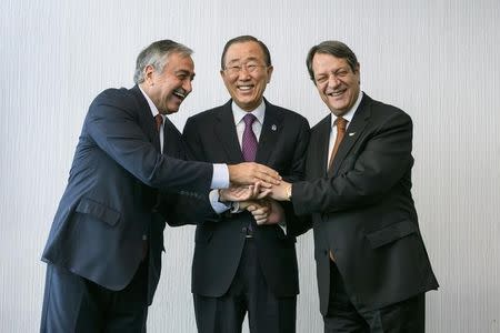 U.N. Secretary-General Ban Ki-moon (C) pose for photographers with Turkish Cypriot leader Mustafa Akinci (L) and Cypriot President Nicos Anastasiades during the Cyprus reunification talks in the Swiss mountain resort of Mont Pelerin, Switzerland November 7, 2016. REUTERS/Fabrice Coffrini/Pool