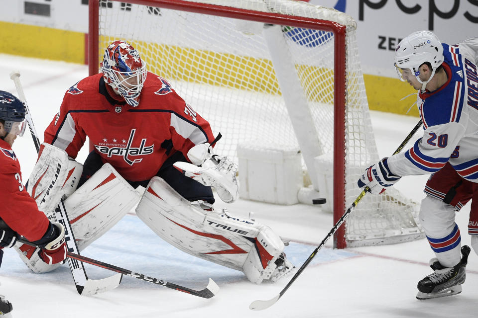 New York Rangers left wing Chris Kreider (20) scores a goal against Washington Capitals goaltender Ilya Samsonov (30) during the third period of an NHL hockey game, Sunday, March 28, 2021, in Washington. (AP Photo/Nick Wass)