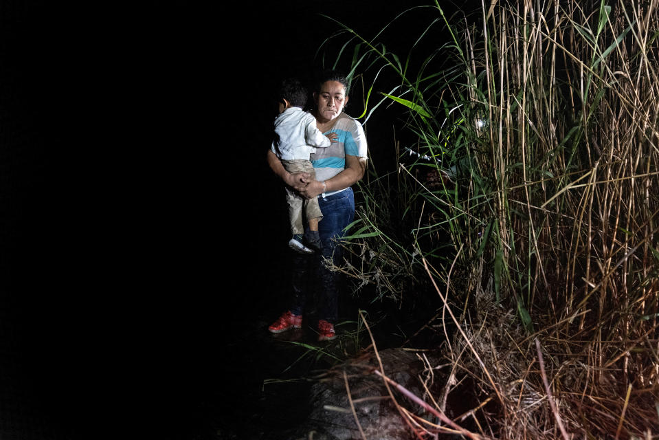 A mother holds her son on the bank of the Rio Grande in Roma, Texas, after being smuggled across the U.S.-Mexico border on April 14, 2021.<span class="copyright">John Moore—Getty Images</span>