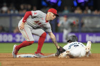 Miami Marlins' Jazz Chisholm Jr. (2) beats the tag by Los Angeles Angels shortstop Zach Neto (9) during the ninth inning of a baseball game, Tuesday, April 2, 2024, in Miami. (AP Photo/Marta Lavandier)