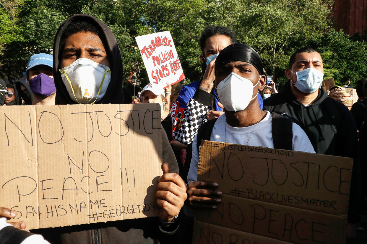 Protesters hold placards in New York's Washington Square Park during a demonstration in response to the killing of George Floyd.