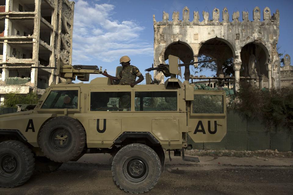 An African Mission in Somalia (AMISOM) soldier keeps guard on top of an armoured vehicle in the old part of Mogadishu November 13, 2013. REUTERS/Siegfried Modola (SOMALIA - Tags: MILITARY CIVIL UNREST)