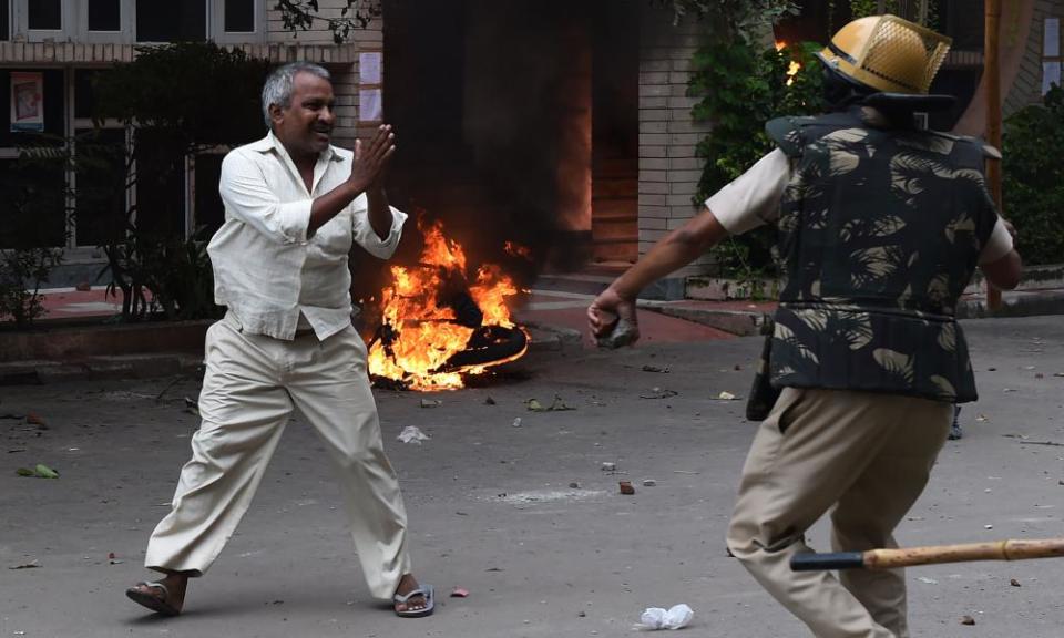 A man appears to plead for his safety during clashes in Panchkula on Friday.