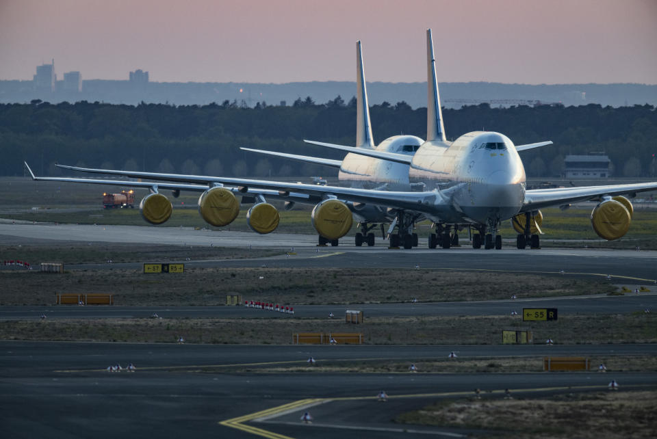 23 April 2020, Hessen, Frankfurt/Main: Covered over turbines, Lufthansa Boeing 747 passenger aircraft that have been temporarily shut down are standing on the tarmac at Frankfurt Airport. The aviation and travel industry with flagships like Lufthansa is particularly hard hit by the coronavirus crisis. Photo: Boris Roessler/dpa (Photo by Boris Roessler/picture alliance via Getty Images)