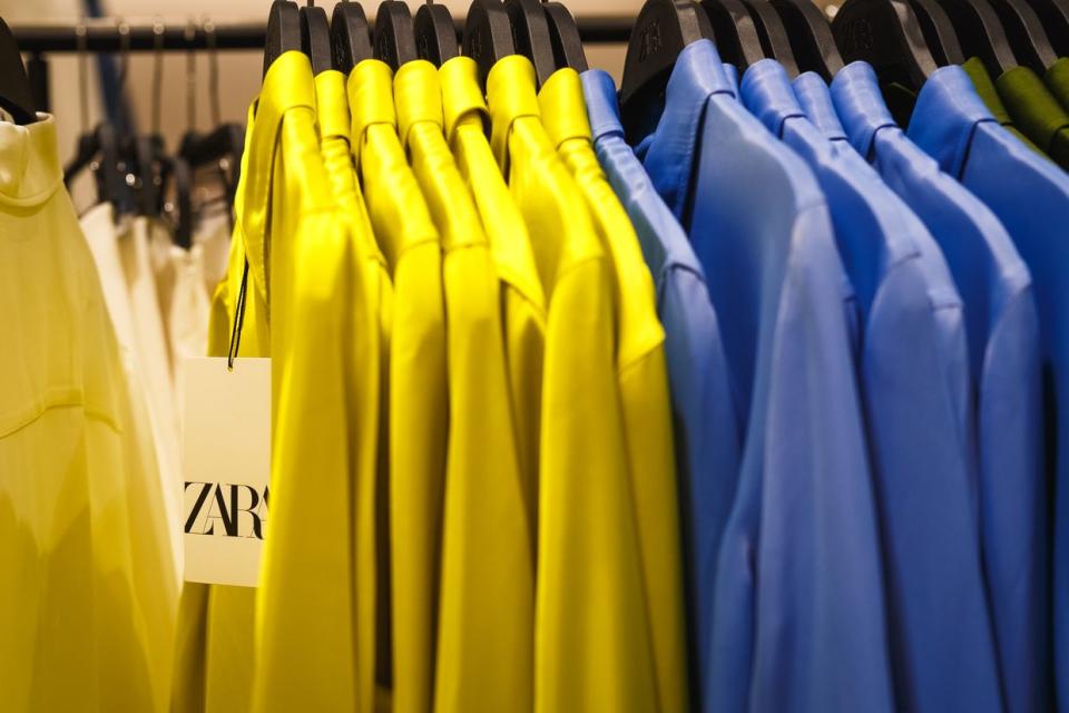 Yellow and blue shirts hang on hangers on a rack in a Zara store, that belongs to the Spanish Inditex group, during brand store reopening in the Respublika Park shopping mall on April 3, 2024 in Kyiv, Ukraine. Since Russia launched a full-scale invasion of Ukraine on February 24, 2022, the Spanish multinational clothing company suspended its operations in Ukraine. (Yurii Stefanyak/Global Images Ukraine via Getty Images)
