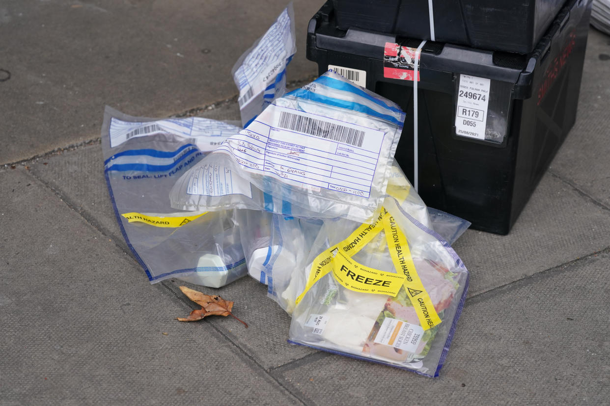 Evidence bags marked as a health hazard and containing produce outside the Tescoe Express store on Fulham Palace Road, west London, which has been closed and a crime scene put in place after a man was arrested on suspicion of contaminating food with a syringe. Police were called on Wednesday evening to a man shouting abuse at people in the street and three supermarkets Tesco Express, Little Waitrose and Sainsbury's Local - have been closed for investigation. Picture date: Thursday August 26, 2021.