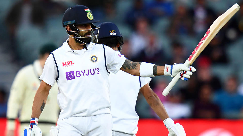 Pictured here, India captain Virat Kohli salutes after making a half century in Adelaide.