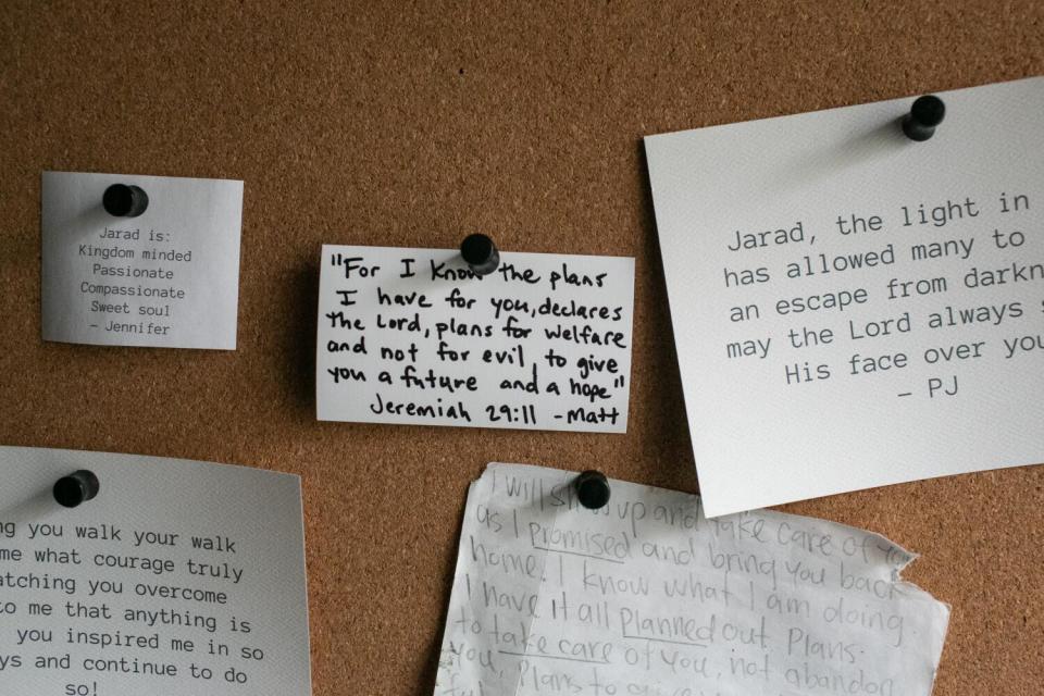 Note cards and letters pinned to a cork board.