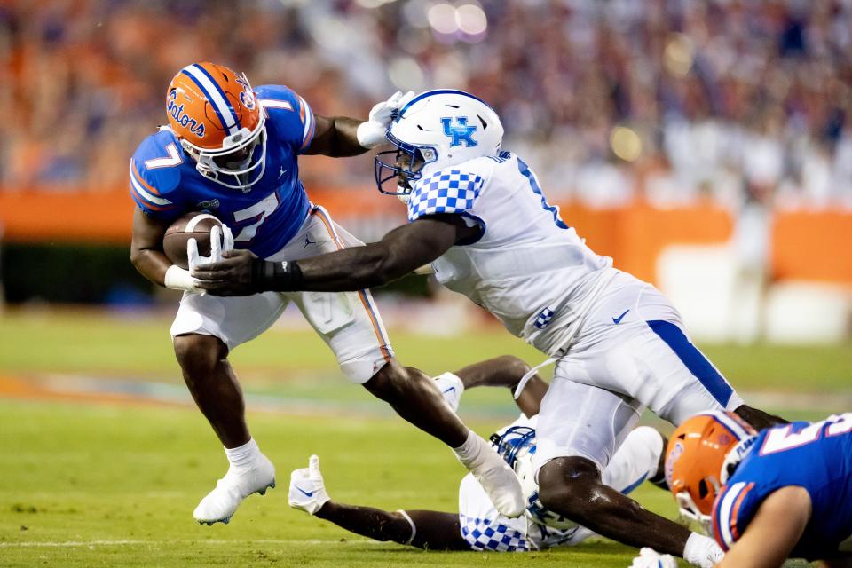 Florida Gators running back Trevor Etienne (7) stiff arms Kentucky Wildcats defensive tackle Deone Walker (0) during the first half at Steve Spurrier Field at Ben Hill Griffin Stadium in Gainesville, FL on Saturday, September 10, 2022. [Matt Pendleton/Gainesville Sun]