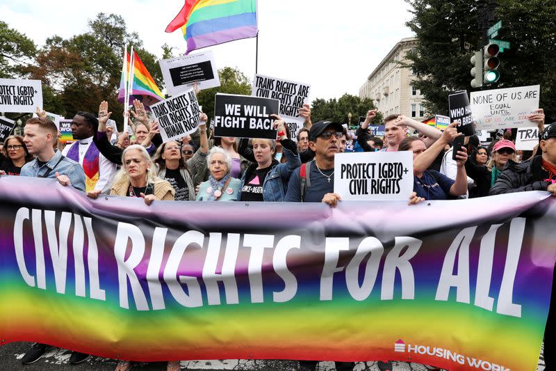 FILE PHOTO: LGBTQ activists and supporters block the street outside the U.S. Supreme Court as it hears arguments in a major LGBT rights case in Washington