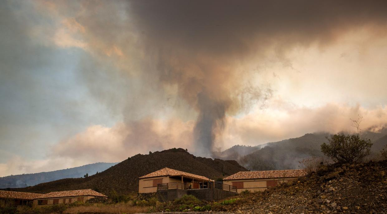 Smoke rises from cooling lava in the residential area of Los Campitos at Los Llanos de Aridane, on the Canary Island of La Palma on September 20, 2021. - A surge of  lava destroyed around 100 homes on Spain's Canary Islands a day after a volcano erupted, forcing 5,000 people to leave the area. The Cumbre Vieja erupted on Sunday, sending vast plumes of thick black smoke into the sky and belching molten lava that oozed down the mountainside on the island of La Palma. (Photo by DESIREE MARTIN / AFP) (Photo by DESIREE MARTIN/AFP via Getty Images)