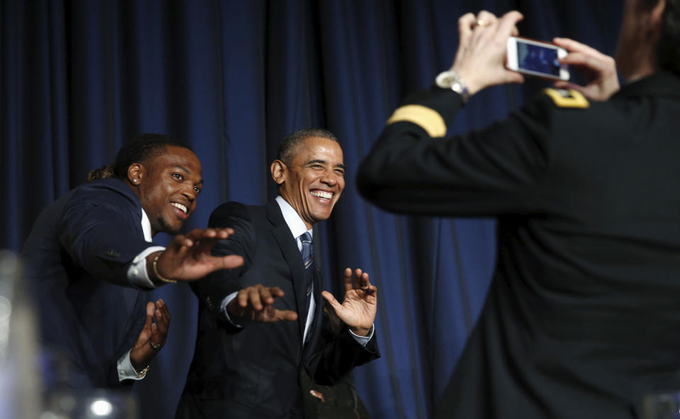 <p>President Barack Obama and college football Heisman Trophy winner Derrick Henry assume the position of the famous trophy after Obama spoke at the National Prayer Breakfast in Washington February 4, 2016. (Kevin Lamarque/Reuters) </p>