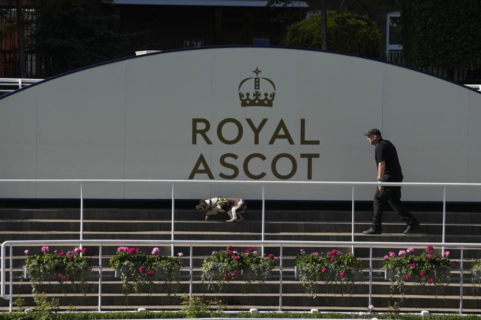 A security officer and dog patrol the grounds, on the second day of of the Royal Ascot horserace meeting, at Ascot Racecourse, in Ascot, England, Wednesday, June 15, 2022. (AP Photo/Alastair Grant)
