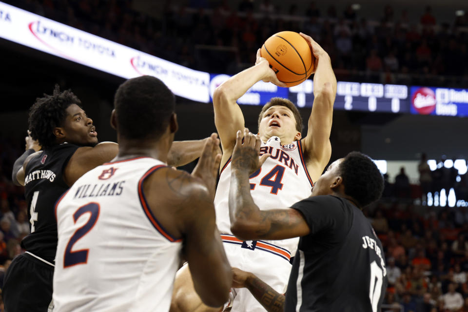 Auburn guard Lior Berman (24) puts up a shot over Mississippi State forward Cameron Matthews (4) and forward D.J. Jeffries (0) for the basket during the second half of an NCAA college basketball game, Saturday, March 2, 2024, in Auburn, Ala. (AP Photo/ Butch Dill)