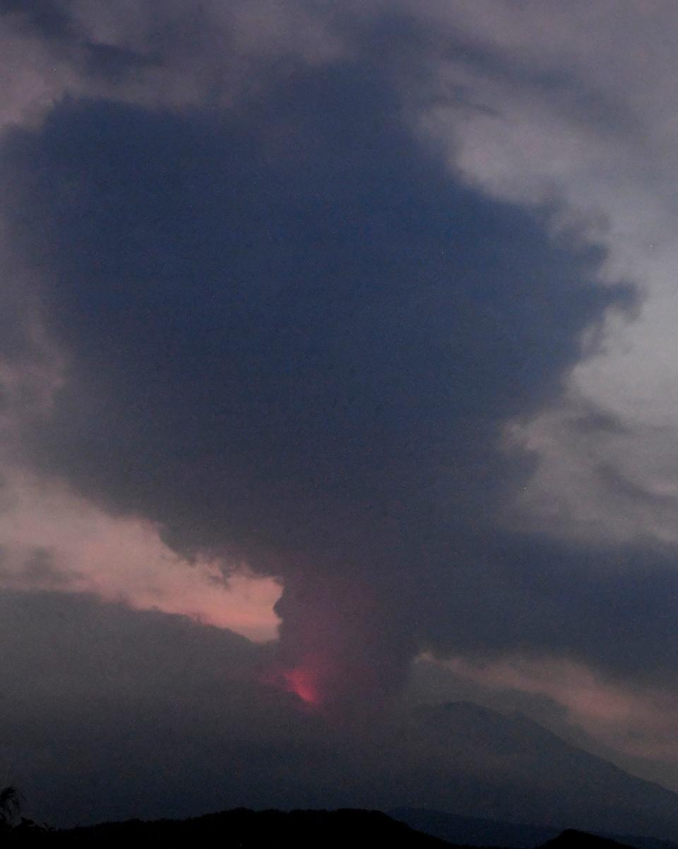 This long exposure image shows the eruption of volcano Sakurajima Sunday night, July 24, 2022, in the view from Tarumizu city, Japan's southern prefecture of Kagoshima.