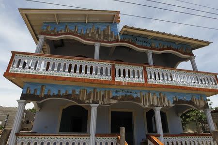 A house, decorated with images of New Orleans, is pictured in the small village of Aguas Calientes, outskirts of Tegucigalpa June 25, 2014. REUTERS/Jorge Cabrera